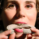 Installation designer Susana Soares bites a 3D-printed biscuit made using insect flour at the ‘Insects au Gratin’ exhibition at the Wellcome Collection in London. Photo: Getty